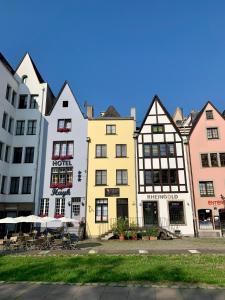 a row of colorful buildings in a city at Altstadthotel Hayk am Rhein in Cologne