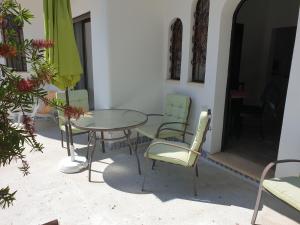 a patio with a table and chairs and an umbrella at OceanOasis Residences Suites in Olhão