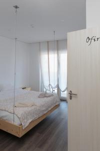 
a bedroom with a bed and a dresser at The Spot Hostel Ofir in Esposende
