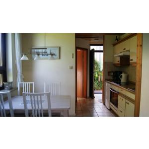 a kitchen and dining room with a table and chairs at Ferienwohnung Möwe in Stein