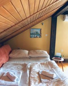 a bedroom with a large bed with a wooden ceiling at Villa Irena in Visoko