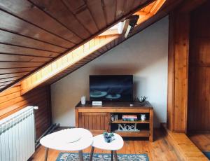 a room with a table and a tv in a attic at Villa Irena in Visoko
