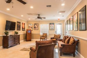 a living room filled with furniture and a tv at The Fountains Resort Orlando at ChampionsGate in Kissimmee