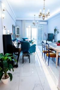 a living room with a dining room table and chairs at Vintage Art home on the sea in Thessaloniki