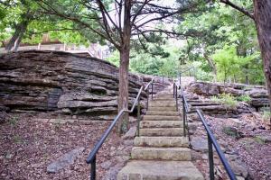 a set of stairs leading up to a rock formation at Beaver Lake Cottages in Eureka Springs