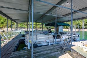 a boat is parked on a dock in a dock at Beaver Lake Cottages in Eureka Springs