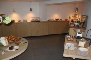 a kitchen with two tables and a counter with food at Domaine de l'Oriu in Serriera