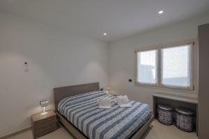 En eller flere senge i et værelse på Casa Fiorella