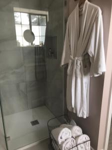 a bathroom with a shower and a towel hanging on a wall at Rathaspeck Manor B&B in Wexford