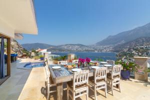 a dining table on a patio with a view of the water at Villa Yar in Kalkan