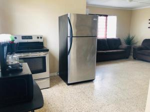 a stainless steel refrigerator in a living room at Arecibo Inn in Arecibo
