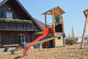 a playground with a slide in front of a house at Weingut Pugl in Leibnitz