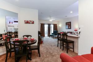 a living room and dining room with a table and chairs at Hideaway at Holiday Hills in Branson