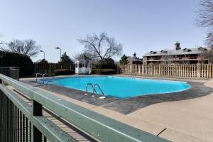 a swimming pool in a yard with a fence at Hideaway at Holiday Hills in Branson