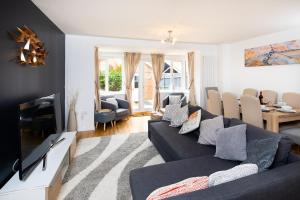 a living room with a couch and a tv at Brightleap Apartments - Modern and Spacious Home From Home 1 mile from M1 - Netflix, Prime Video, PS5 - Sleeps 11 in Milton Keynes