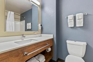 a bathroom with a toilet, sink, and mirror at Extended Stay America Suites - San Ramon - Bishop Ranch - East in San Ramon
