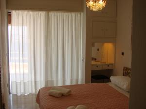 a bedroom with a bed with two towels on it at Katerina's Maisonnette in Loutraki