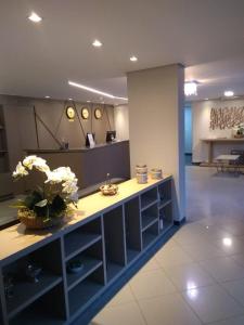 a lobby with a counter with flowers on it at Ilhabela Park Hotel in Brasilia