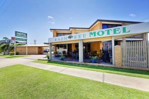a building with a sign on the front of it at Raintree Motel in Townsville