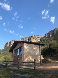 a small building with a mountain in the background at La Granera in Girona