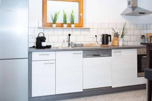 a kitchen with white cabinets and a sink at dreamlike APARTMENT in Oberndorf