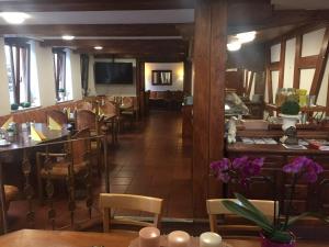 a dining room with chairs and a table with purple flowers at Hotel City Faber in Worms