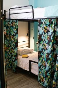 a bunk bed with a door open to a bedroom at NATIVUS Art-Hostel in San José