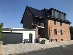 a large brick house with a garage at Apartment Meine in Meine
