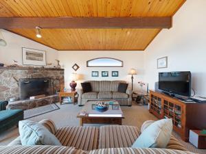 a living room with a couch and a fireplace at Ocean Waves in Gleneden Beach