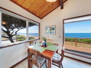 a dining room with a table and views of the ocean at Ocean Waves in Gleneden Beach +30 photos