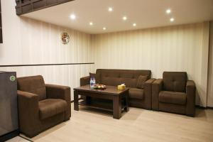 a waiting room with two chairs and a table at Residence North Avenue, small center in Yerevan