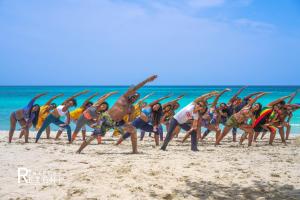 a group of people doing yoga on the beach at Yoga Dreams Negril in Negril