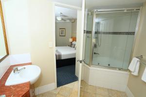 a bathroom with a shower and a sink and a toilet at Landmark Resort in Mooloolaba