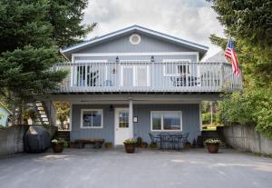 ein Haus mit einer Terrasse und einem Balkon in der Unterkunft Bears Den Alaska Lodging in Seward