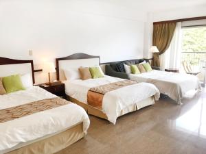 Dot Hotel Yanbaruにあるベッド