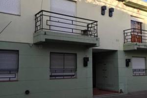 a building with two balconies and a patio on it at Dpto Low Cost Terraza Alem Costanera in Gualeguaychú