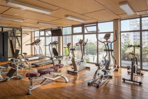 a gym with several treadmills and exercise bikes at G Mekong Hotel Phom Penh in Phnom Penh