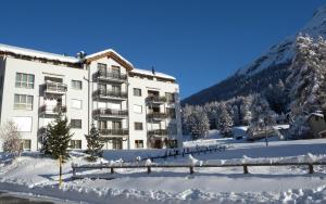 a building with snow in front of a mountain at Surpunt 44 in St. Moritz