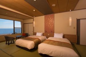 A bed or beds in a room at Umiusagi
