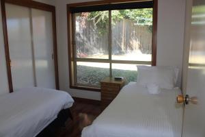a bedroom with two beds and a window at Australian Home Away @ Doncaster Anderson Creek 2 in Doncaster East