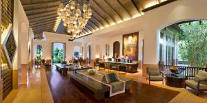 a living room with couches and chairs and a chandelier at Anantara Bophut Koh Samui Resort in Bophut