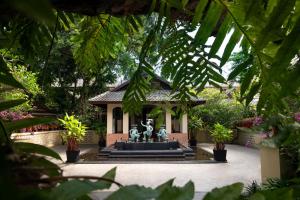 a fountain in front of a building with a statue at Anantara Bophut Koh Samui Resort in Bophut