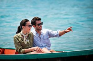 a man and a woman sitting in a boat at Anantara Bophut Koh Samui Resort in Bophut
