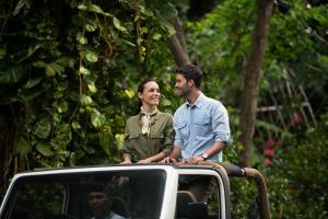 a man and woman sitting on the roof of a car at Anantara Bophut Koh Samui Resort in Bophut