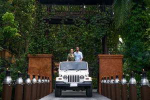 two people standing on top of a white jeep at Anantara Bophut Koh Samui Resort in Bophut