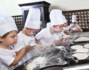 a group of chefs preparing food in a kitchen at Anantara Bophut Koh Samui Resort in Bophut
