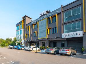 a row of cars parked in front of a building at De Sweet Boutique Hotel in Johor Bahru