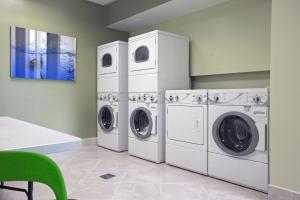 a laundry room with two washer and dryer at Hotel Nexus; BW Signature Collection in Seattle