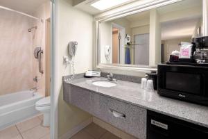 a bathroom with a sink and a microwave at Hotel Nexus; BW Signature Collection in Seattle
