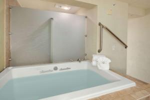a large white bath tub in a bathroom at Hotel Nexus; BW Signature Collection in Seattle